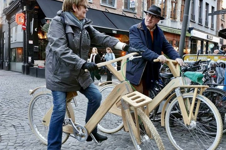 a group of people riding on the back of a bicycle