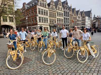 a group of people riding on the back of a bicycle